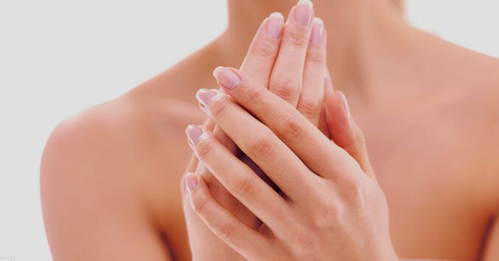 Beautiful woman (MODEL) rubbing her soft hands together
