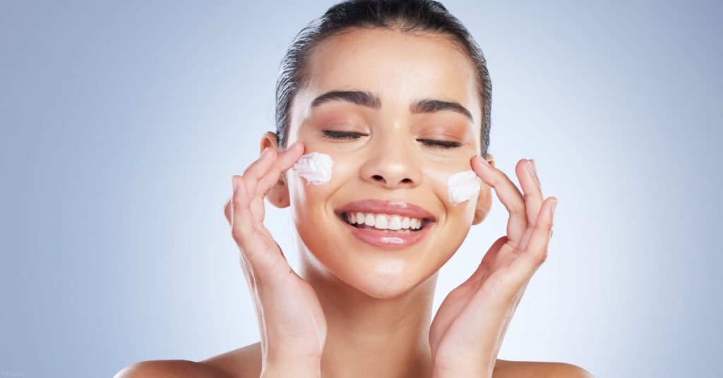 woman with skin care products on her face (model)