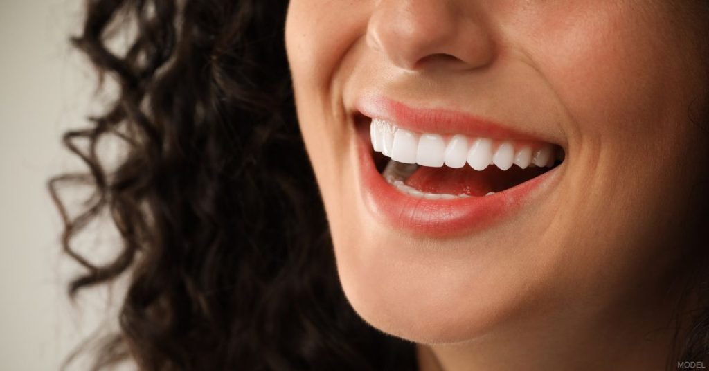 Close up of a woman smiling. (Model)